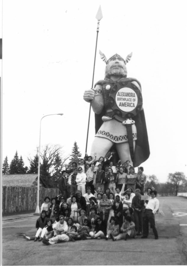Old pic of the Rotary Youth Exchange posing with Big Ole while he was directly in front of the Runestone Museum. How many thousands (maybe millions?) of people have posed with our Viking king over the years!? Photo courtesy of Douglas County Historical Society.
