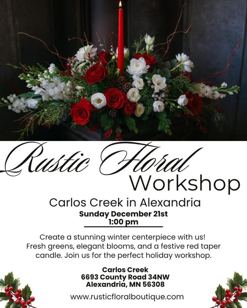 A festive Winter Centerpiece featuring red and white flowers, greenery, and a tall red taper candle. Join our Rustic Floral Workshop on December 21st at 1 pm in Alexandria, MN—location and website details included.